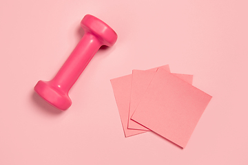 Image showing Weight and paper stickers. Monochrome stylish composition in pink color. Top view, flat lay.