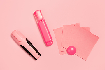 Image showing Markers and paper stickers. Monochrome stylish composition in pink color. Top view, flat lay.