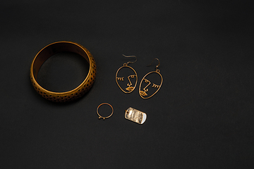 Image showing Fashion look. Monochrome stylish composition in black and gold colors. Top view, flat lay.