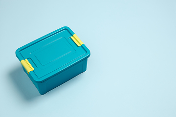 Image showing Closed lunch box. Monochrome stylish composition in blue color. Top view, flat lay.