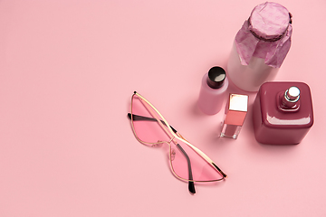 Image showing Cosmetics, fashion. Monochrome stylish composition in pink color. Top view, flat lay.