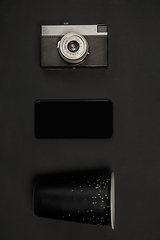 Image showing Gadgets and eyewear. Monochrome stylish composition in black color. Top view, flat lay.