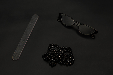 Image showing Fashion look. Monochrome stylish composition in black color. Top view, flat lay.