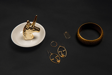 Image showing Fashion look. Monochrome stylish composition in black and gold colors. Top view, flat lay.