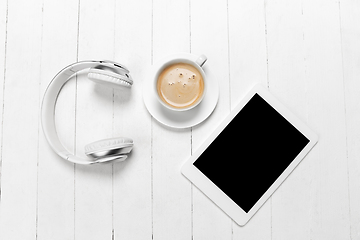 Image showing Gadgets and coffee. Monochrome stylish composition in white color. Top view, flat lay.