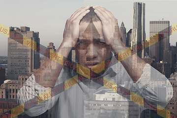 Image showing Stressed man holding head with hands on abstract city background. Double exposure. Virus alert, coronavirus pandemic.