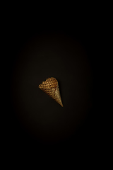 Image showing Golden icecream waffle on a black background, stylish minimalistic composition with copyspace