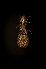 Image showing Golden pineapple on a black background, stylish minimalistic composition with copyspace