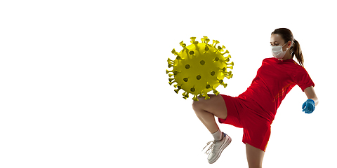 Image showing Sportswoman kicking, punching coronavirus, protection and treatment concept, flyer