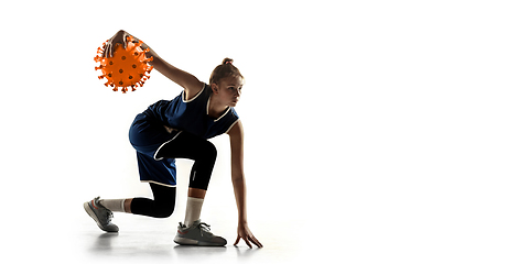 Image showing Sportswoman kicking, punching coronavirus, protection and treatment concept, flyer