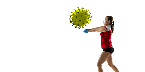 Image showing Sportswoman kicking, punching coronavirus, protection and treatment concept, flyer