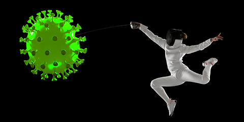 Image showing Sportswoman kicking, punching coronavirus, protection and treatment concept, flyer