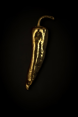 Image showing Golden pepper on a black background, stylish minimalistic composition with copyspace