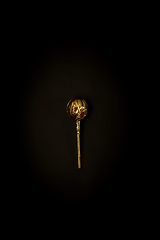 Image showing Golden candy on a black background, stylish minimalistic composition with copyspace