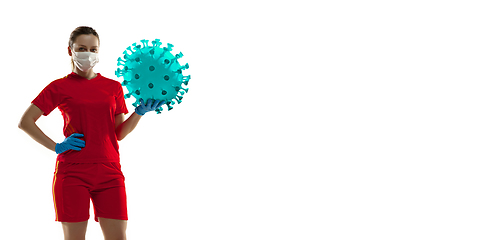 Image showing Sportswoman kicking, punching coronavirus, protection and treatment concept, flyer