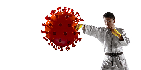 Image showing Sportsman kicking, punching coronavirus, protection and treatment concept, flyer