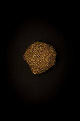 Image showing Golden stone on a black background, stylish minimalistic composition with copyspace