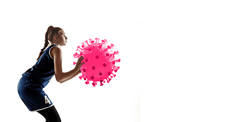 Image showing Sportswoman kicking, punching coronavirus, protection and treatment concept, flyer