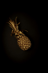 Image showing Golden pineapple on a black background, stylish minimalistic composition with copyspace