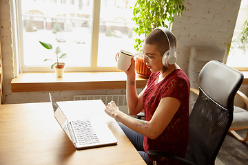 Image showing Woman working from home during coronavirus or COVID-19 quarantine, remote office concept