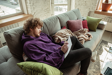 Image showing Man working from home during coronavirus or COVID-19 quarantine, remote office concept