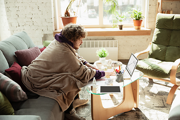 Image showing Man working from home during coronavirus or COVID-19 quarantine, remote office concept