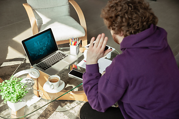 Image showing Man working from home during coronavirus or COVID-19 quarantine, remote office concept