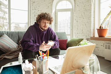 Image showing Man working from home during coronavirus or COVID-19 quarantine, remote office concept