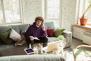 Image showing Man working from home during coronavirus or COVID-19 quarantine, remote office concept