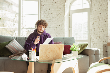 Image showing Man working from home during coronavirus or COVID-19 quarantine, remote office concept