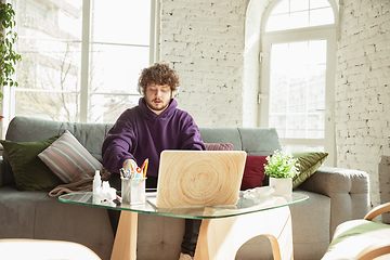 Image showing Man working from home during coronavirus or COVID-19 quarantine, remote office concept