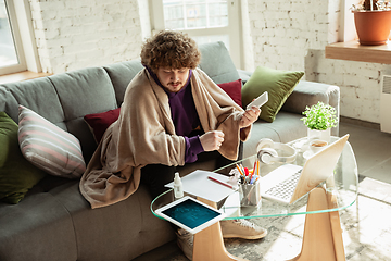 Image showing Man working from home during coronavirus or COVID-19 quarantine, remote office concept