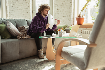 Image showing Man working from home during coronavirus or COVID-19 quarantine, remote office concept