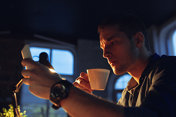 Image showing Man working in office alone during coronavirus or COVID-19 quarantine, staying to late night