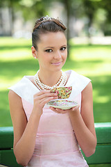 Image showing beautiful smiling girl drink coffee