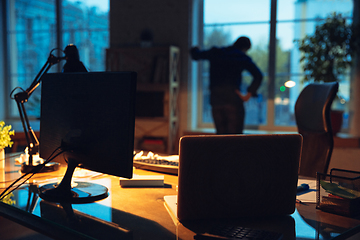 Image showing Man working in office alone during coronavirus or COVID-19 quarantine, staying to late night