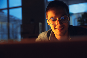 Image showing Man working in office alone during coronavirus or COVID-19 quarantine, staying to late night