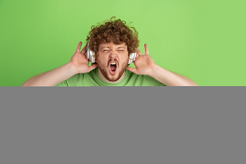 Image showing Caucasian young man\'s monochrome portrait on green studio background