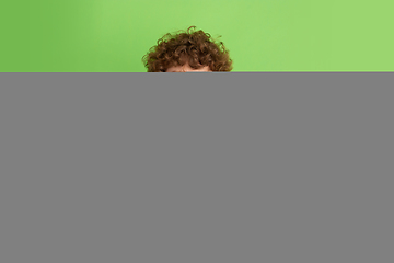 Image showing Caucasian young man\'s monochrome portrait on green studio background