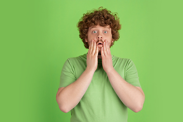 Image showing Caucasian young man\'s monochrome portrait on green studio background