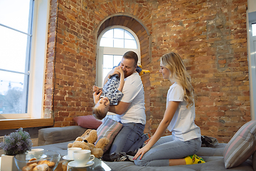 Image showing Mother, father and son at home having fun, comfort and cozy concept