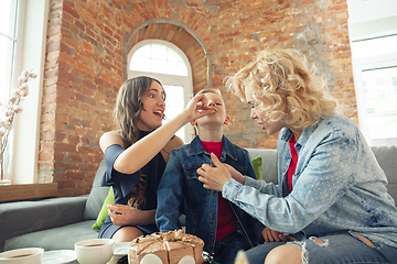 Image showing Mother, son and sister at home having fun, comfort and cozy concept, celebrating birthday