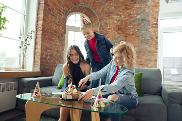 Image showing Mother, son and sister at home having fun, comfort and cozy concept, celebrating birthday