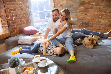 Image showing Mother, father and son at home having fun, comfort and cozy concept