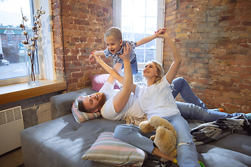 Image showing Mother, father and son at home having fun, comfort and cozy concept