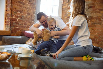 Image showing Mother, father and son at home having fun, comfort and cozy concept