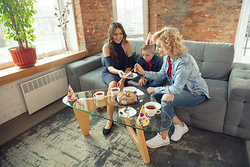 Image showing Mother, son and sister at home having fun, comfort and cozy concept, celebrating birthday