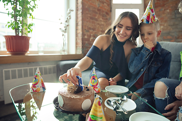 Image showing Mother, son and sister at home having fun, comfort and cozy concept, celebrating birthday