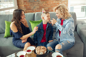 Image showing Mother, son and sister at home having fun, comfort and cozy concept, celebrating birthday