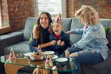 Image showing Mother, son and sister at home having fun, comfort and cozy concept, celebrating birthday